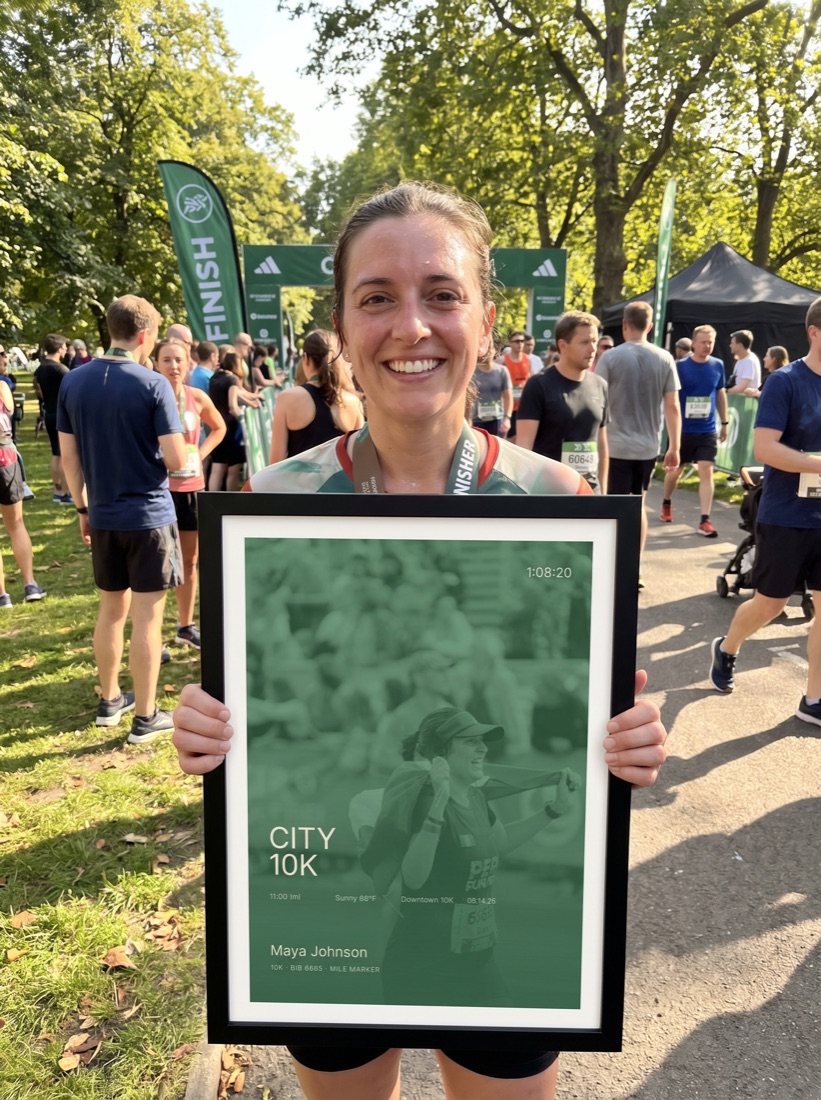 10K finisher holding her print at a community race